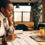 Project manager in a cozy workspace reviewing budget plans and forecasts